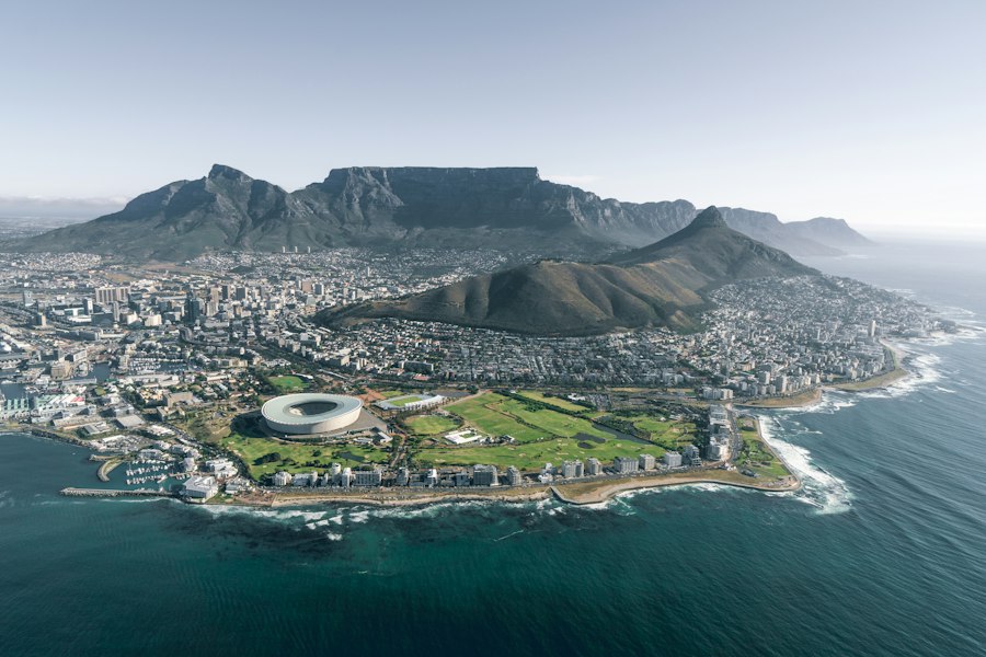 Aerial view of Cape Town with Table Mountain rising behind the city and Atlantic coast