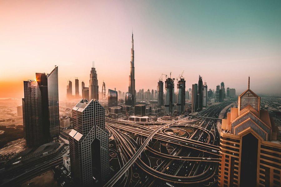 Dubai skyline at sunset with the Burj Khalifa above the city interchange