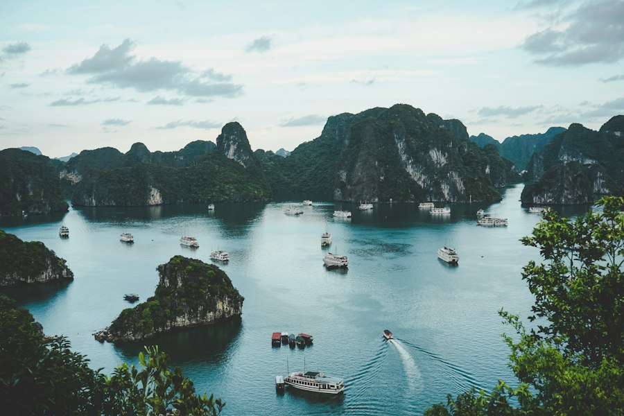 Limestone karst islands and cruise boats scattered across Ha Long Bay in Vietnam